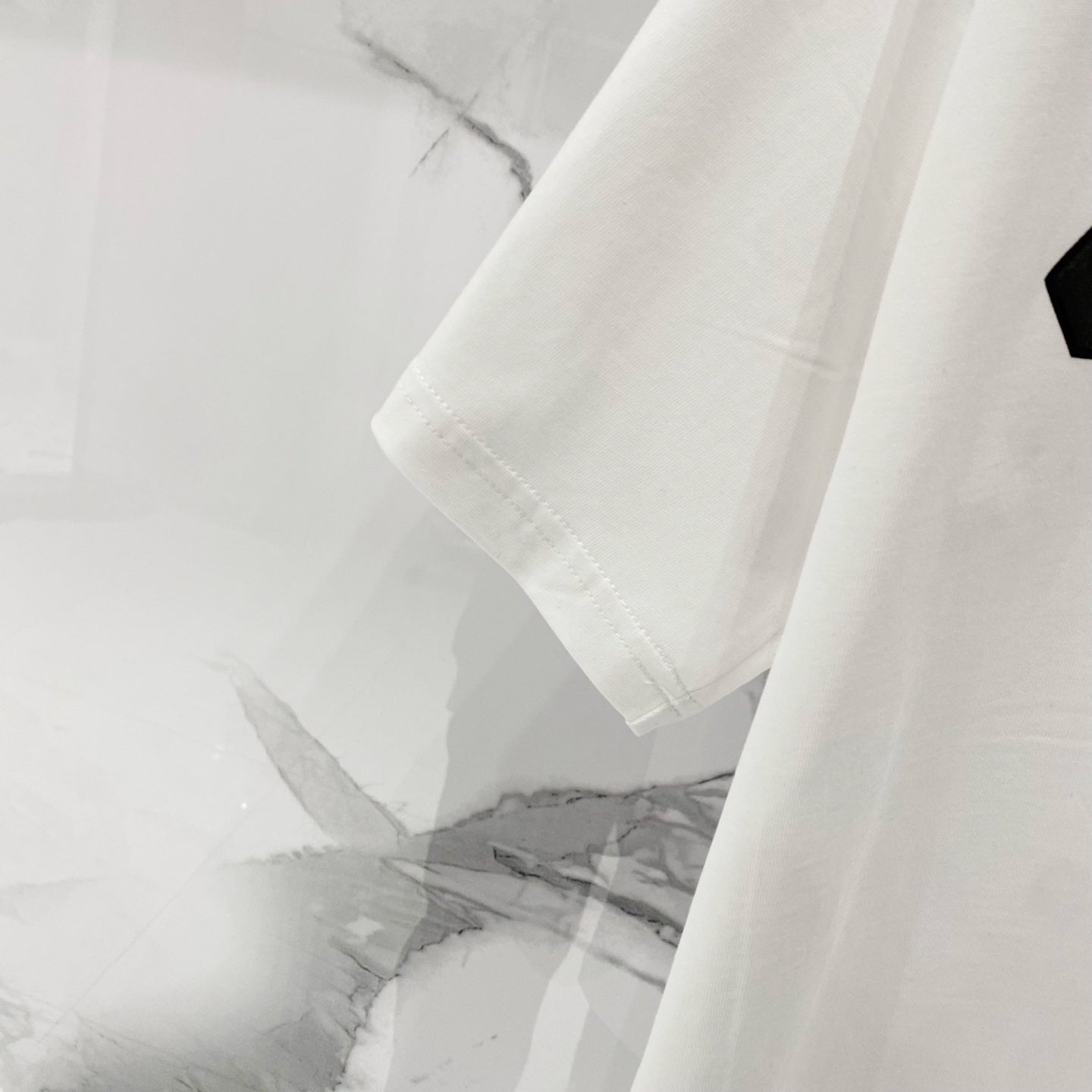 Off-White T-shirt sleeve and hem, off-white crewneck T-shirt