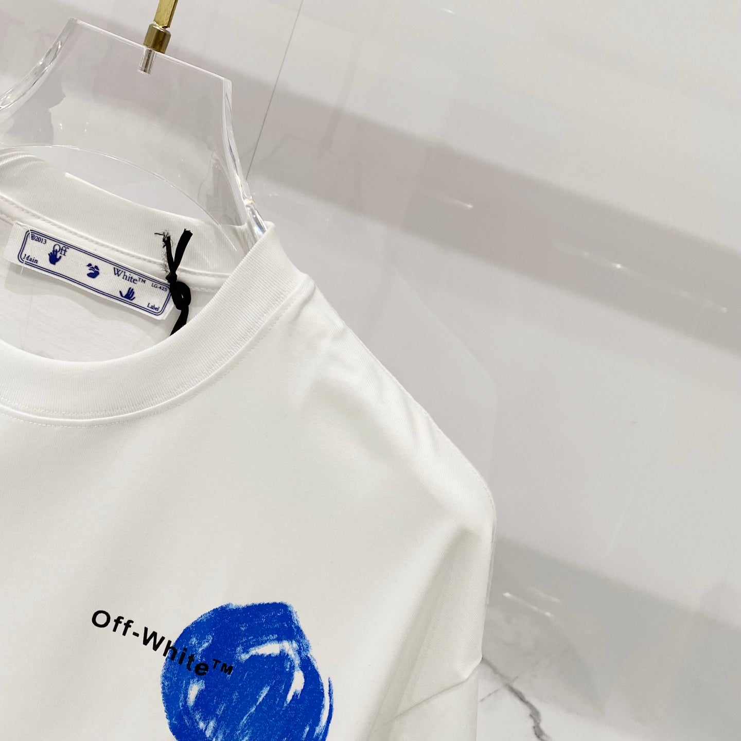 Off-White white T-shirt with blue circular graphic on side