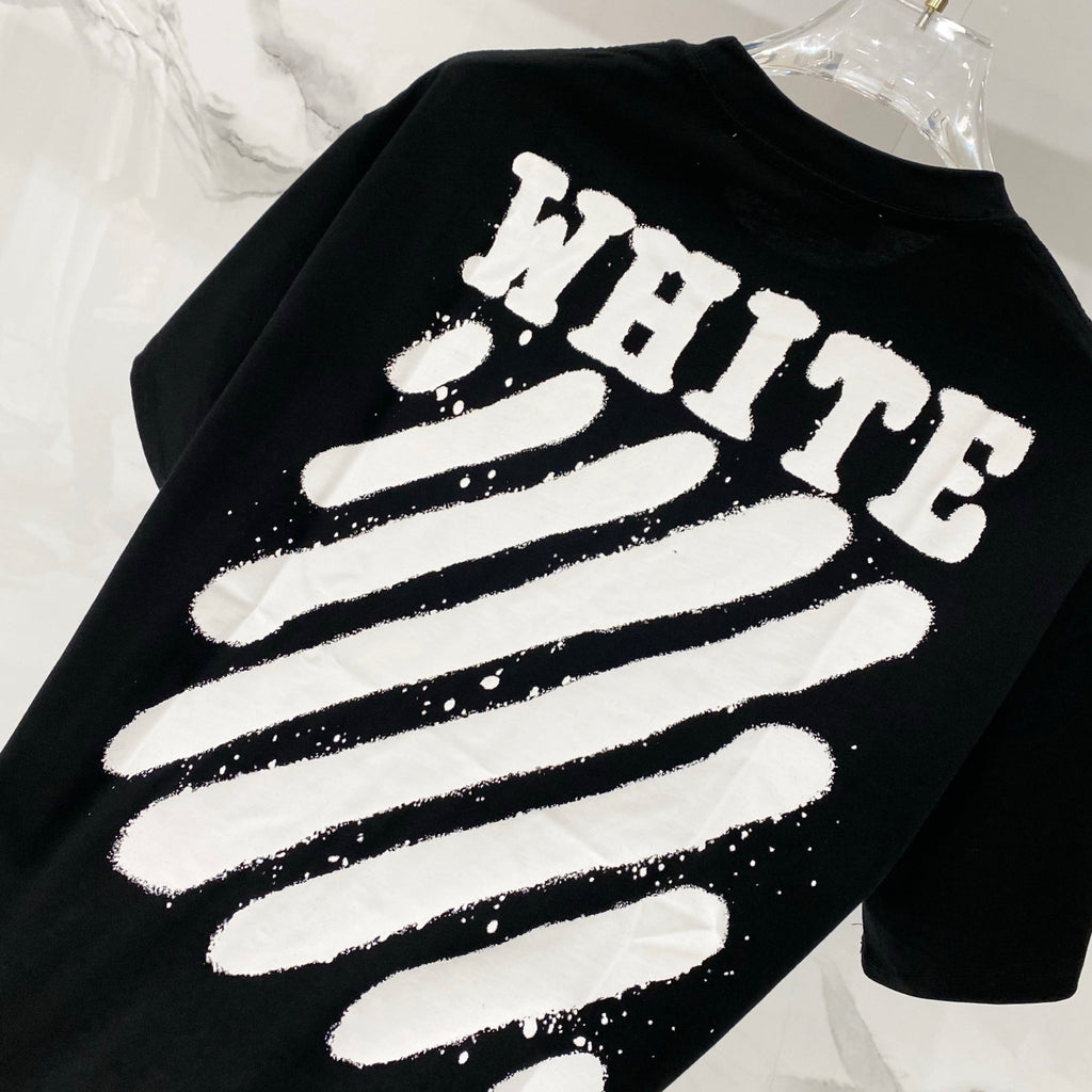 Black T-shirt closeup with 'WHITE' striped graphic print