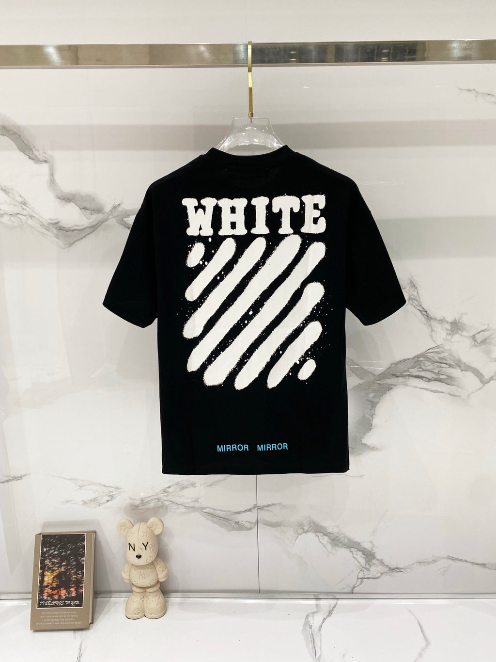 Black T-shirt with 'WHITE' text and diagonal striped graphic on back