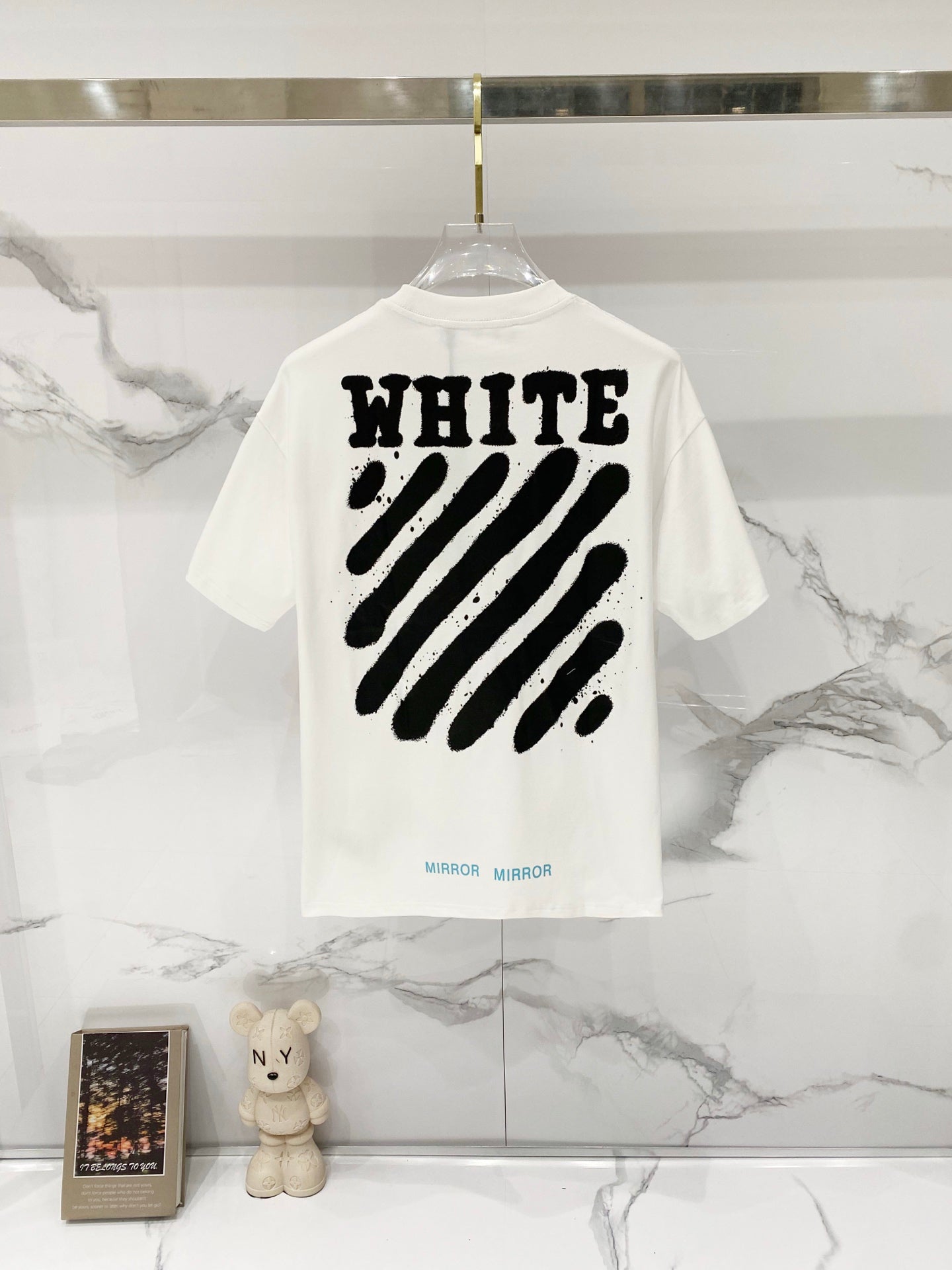 White T-shirt back with large black “WHITE” text and diagonal stripe graphic