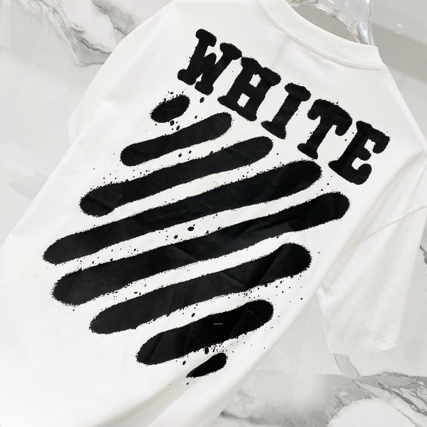 White T-shirt back with bold black brush-style “OFF” graphic