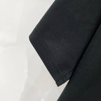 Black T-shirt sleeve hem with neat stitched edge