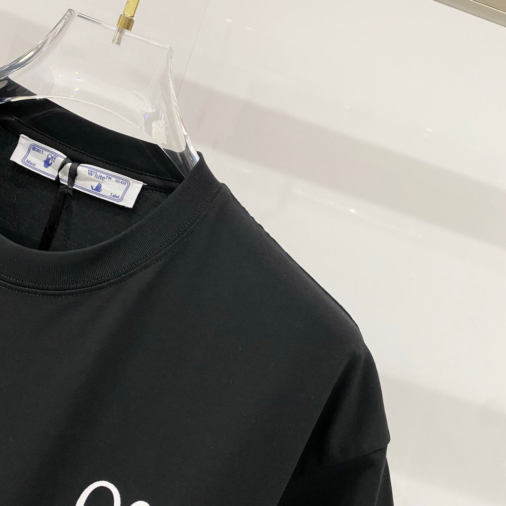Black T-shirt closeup of crewneck and brand label