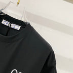 Black T-shirt closeup of crewneck and brand label
