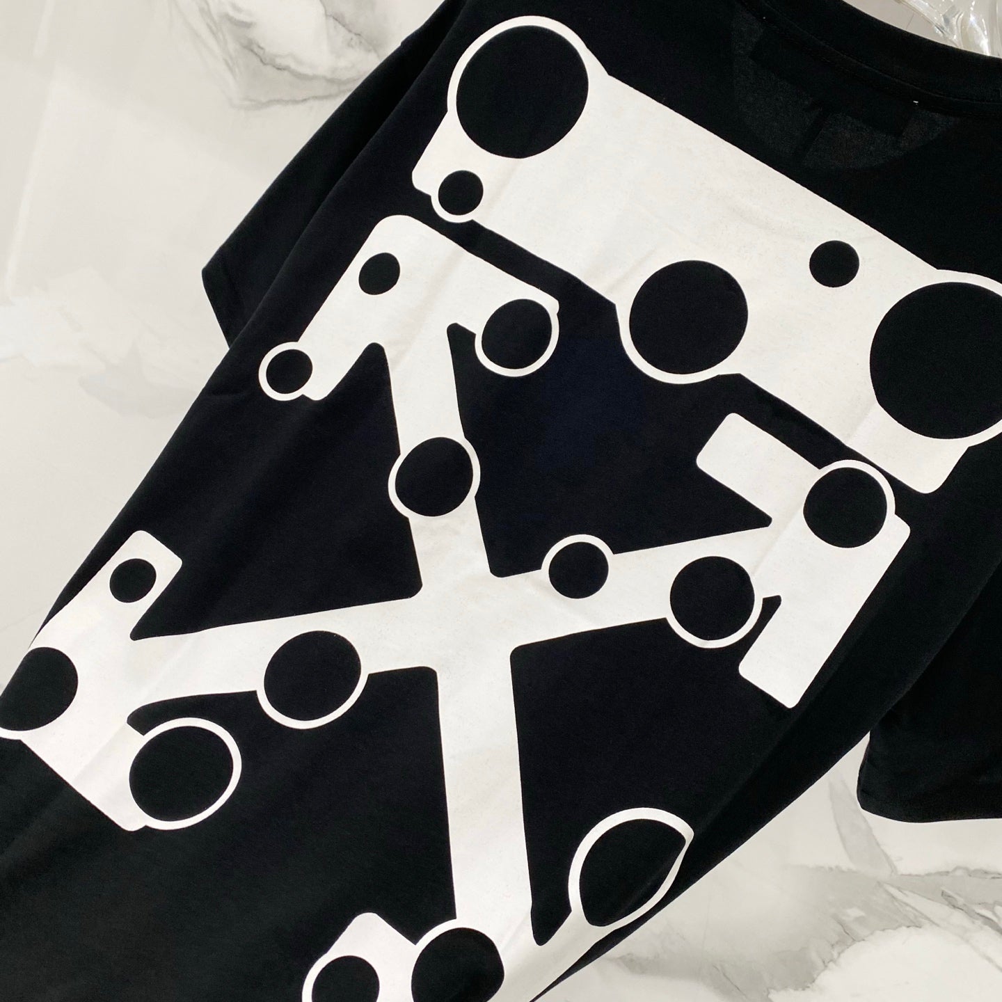 Black T-shirt with oversized white abstract geometric logo print