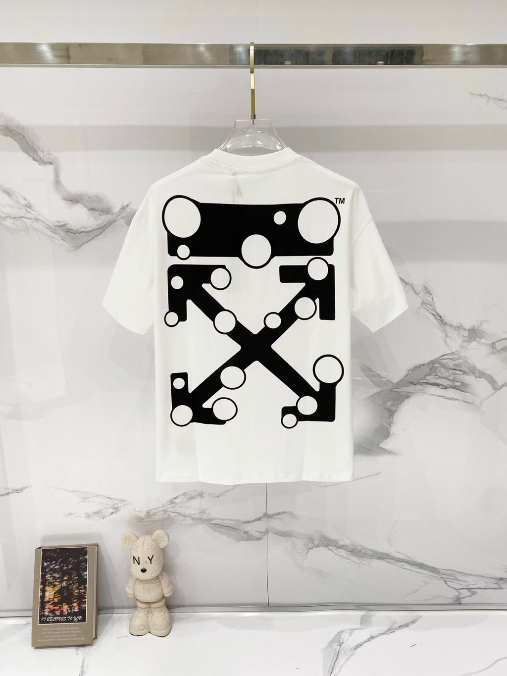 Off-white t-shirt with large black geometric graphic on the back.