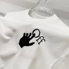 Off-white t-shirt close-up of black logo graphic on the chest.