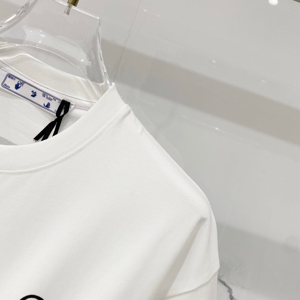 Off-white t-shirt side view on a clear hanger, with partial front logo visible.