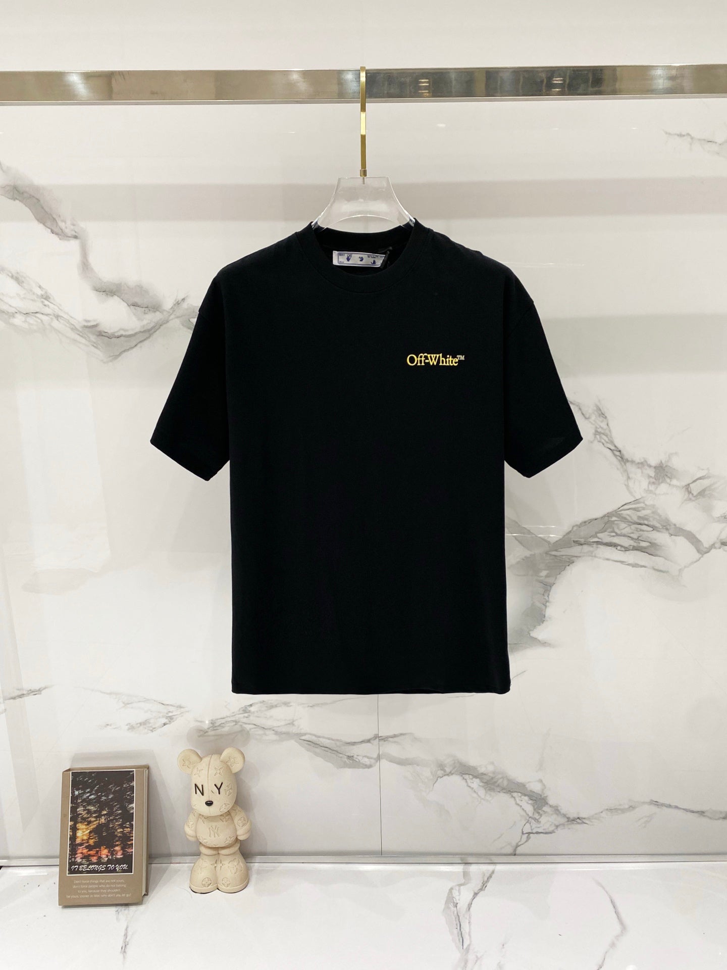 Black T-shirt with small Off-White logo print at chest.