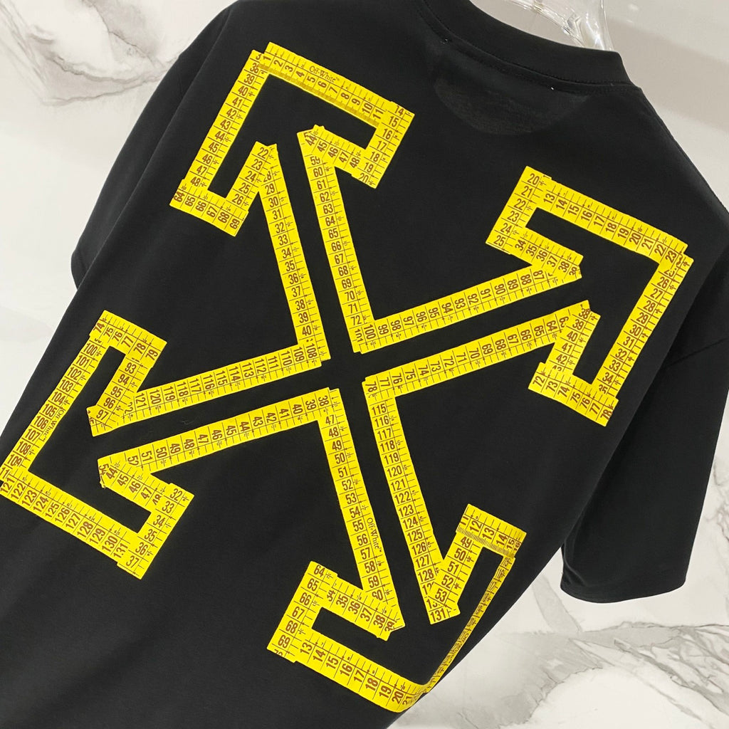 Black T-shirt with large yellow arrows and text graphic detail.