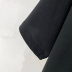 Black T-shirt sleeve hem with stitched seam.