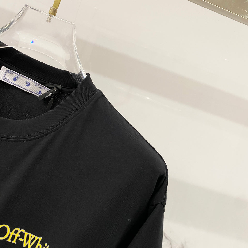 Black T-shirt sleeve and neckline with Off-White neck tag.