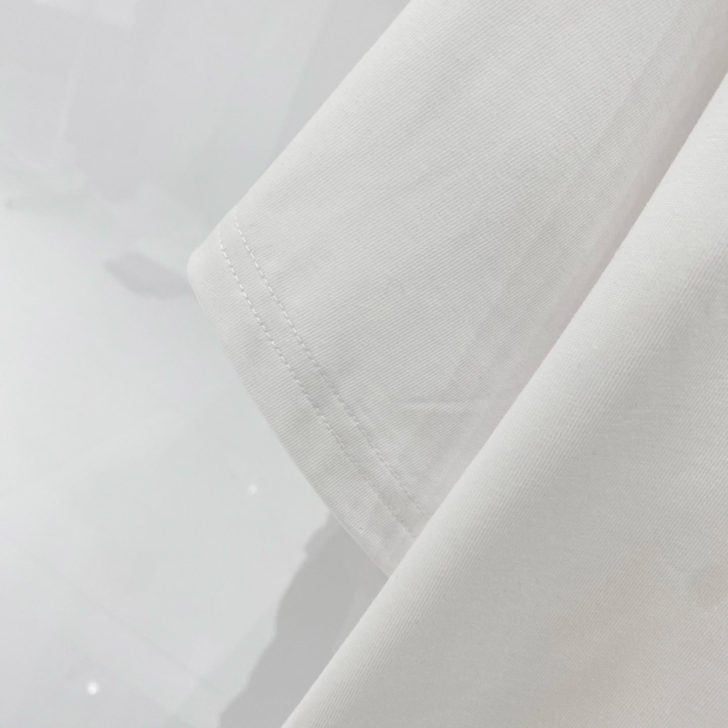 Off-White T-shirt sleeve and hem detail in off-white