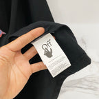 Off-White black T-shirt care label with giraffe logo, shown on collar