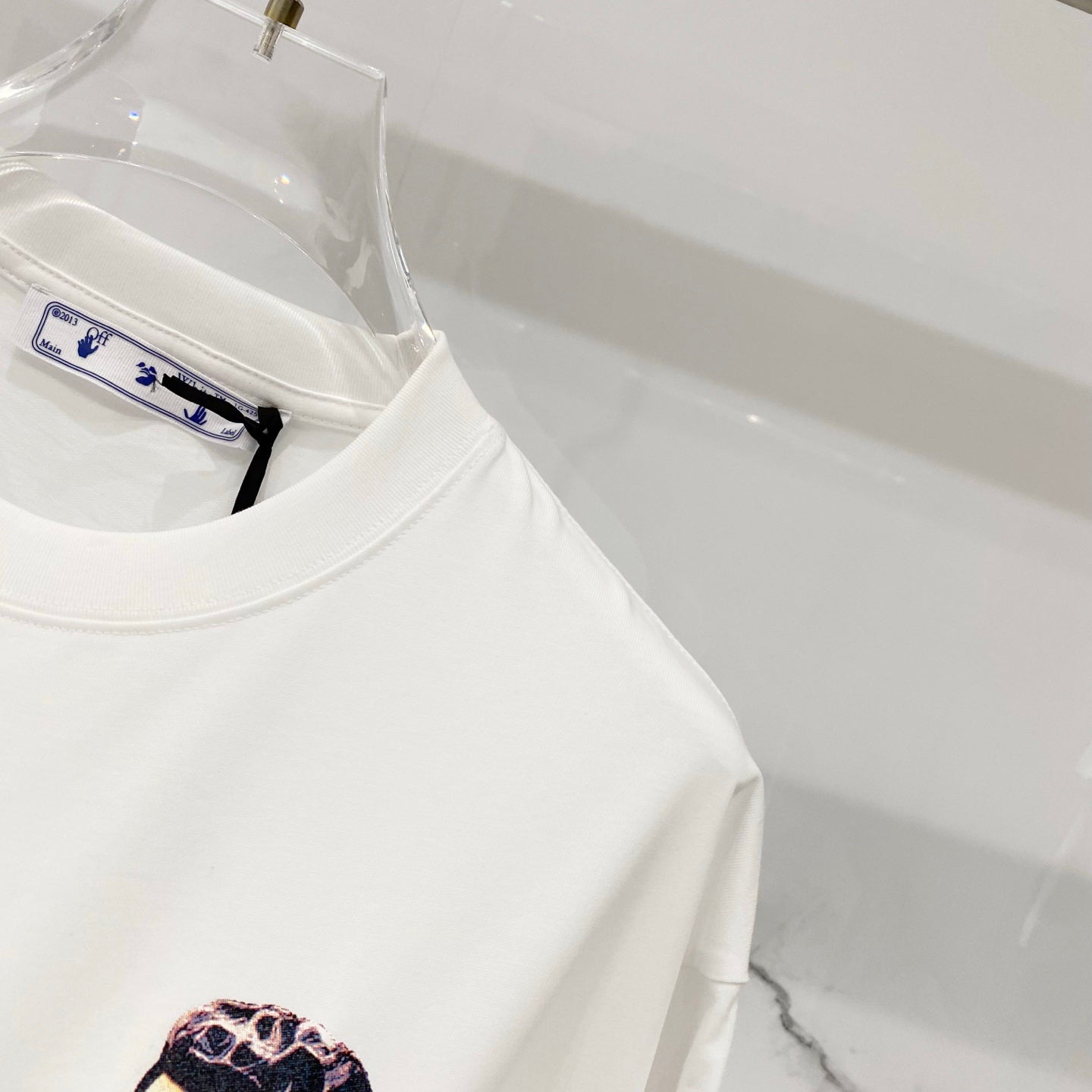 Off-white T-shirt body with crew neck and inner label patch