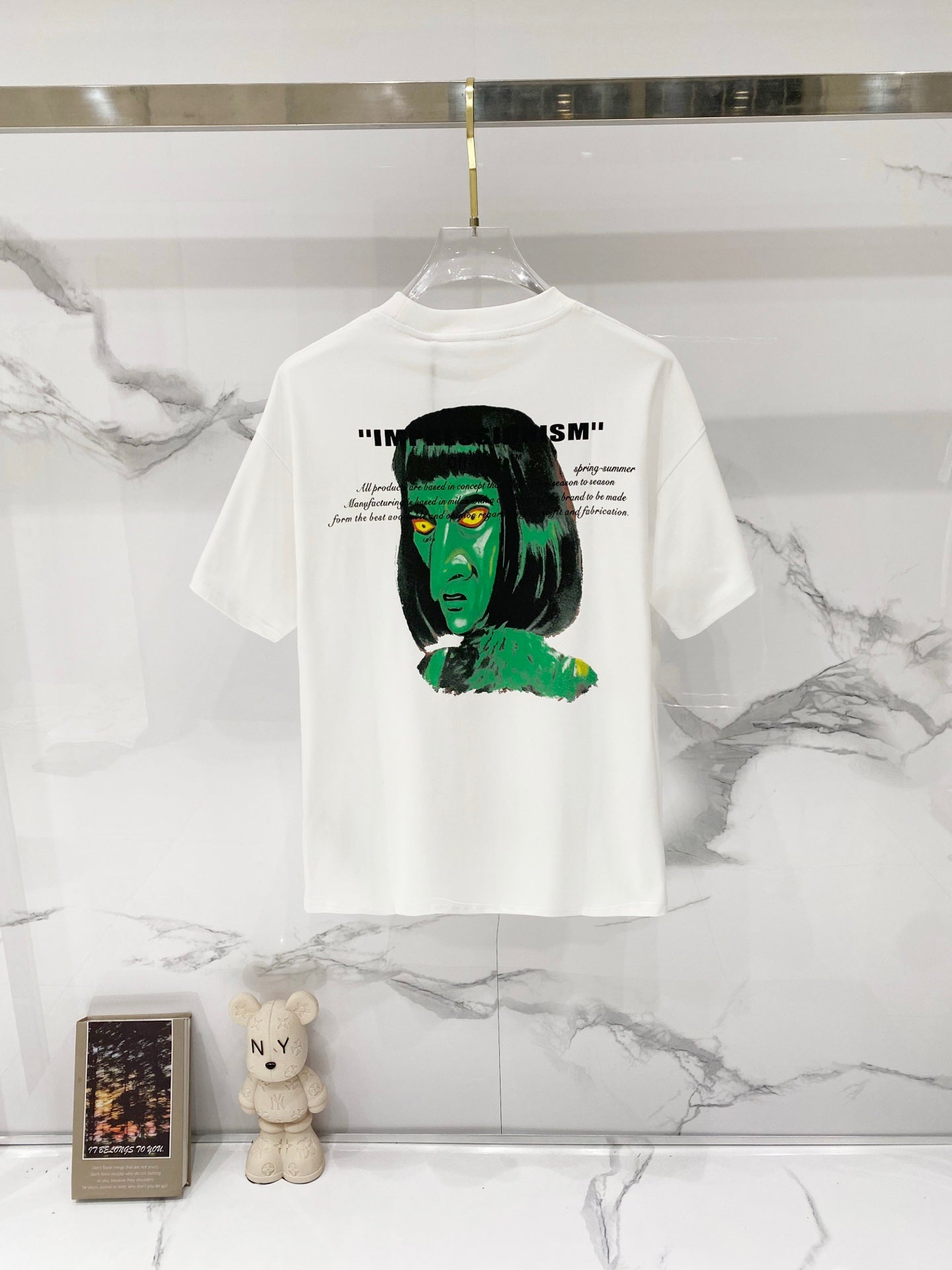 Graphic T-shirt, off-white, back print with black text and green face illustration