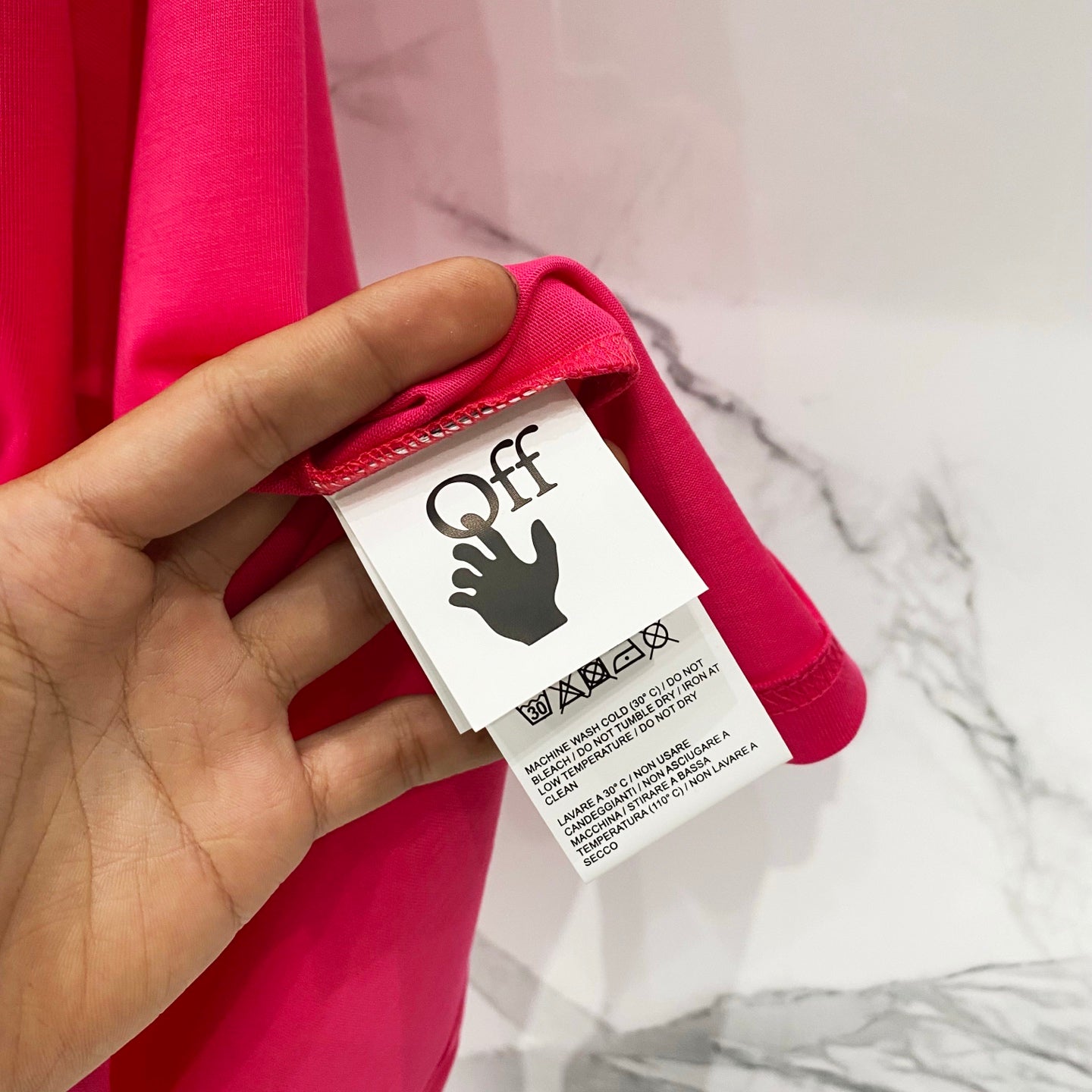 Off White red T-shirt with care label detail near the collar.