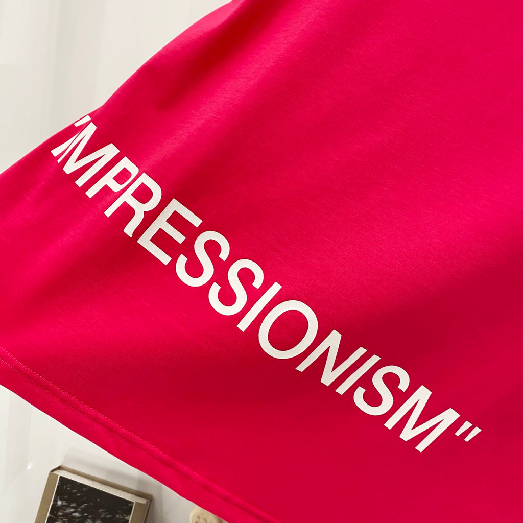 Off White red T-shirt close-up of “IMPRESSIONISM” text print across fabric.