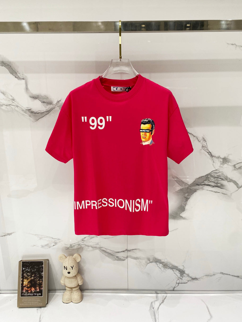 Off White graphic T-shirt in red with “99” and face print on chest.