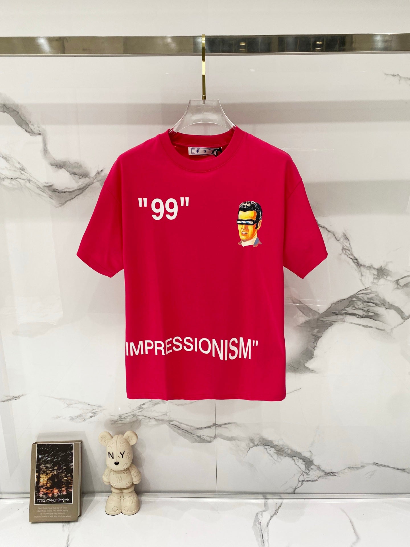 Off White graphic T-shirt in red with “99” and face print on chest.