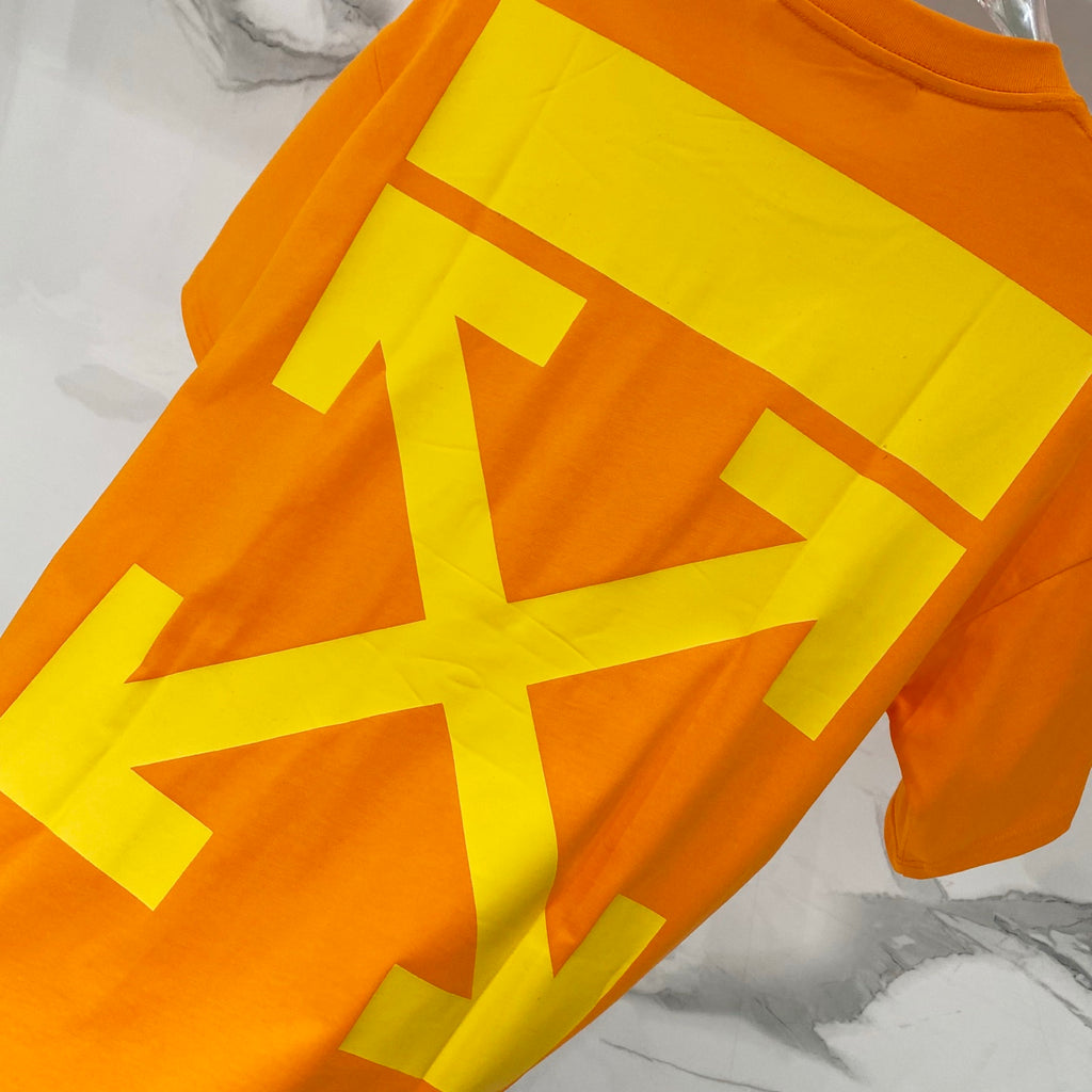Orange T-shirt with oversized yellow graphic arrows on front