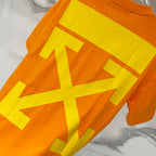 Orange T-shirt with oversized yellow graphic arrows on front