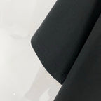 Off-White T-shirt sleeve and side seam close-up, black knit fabric
