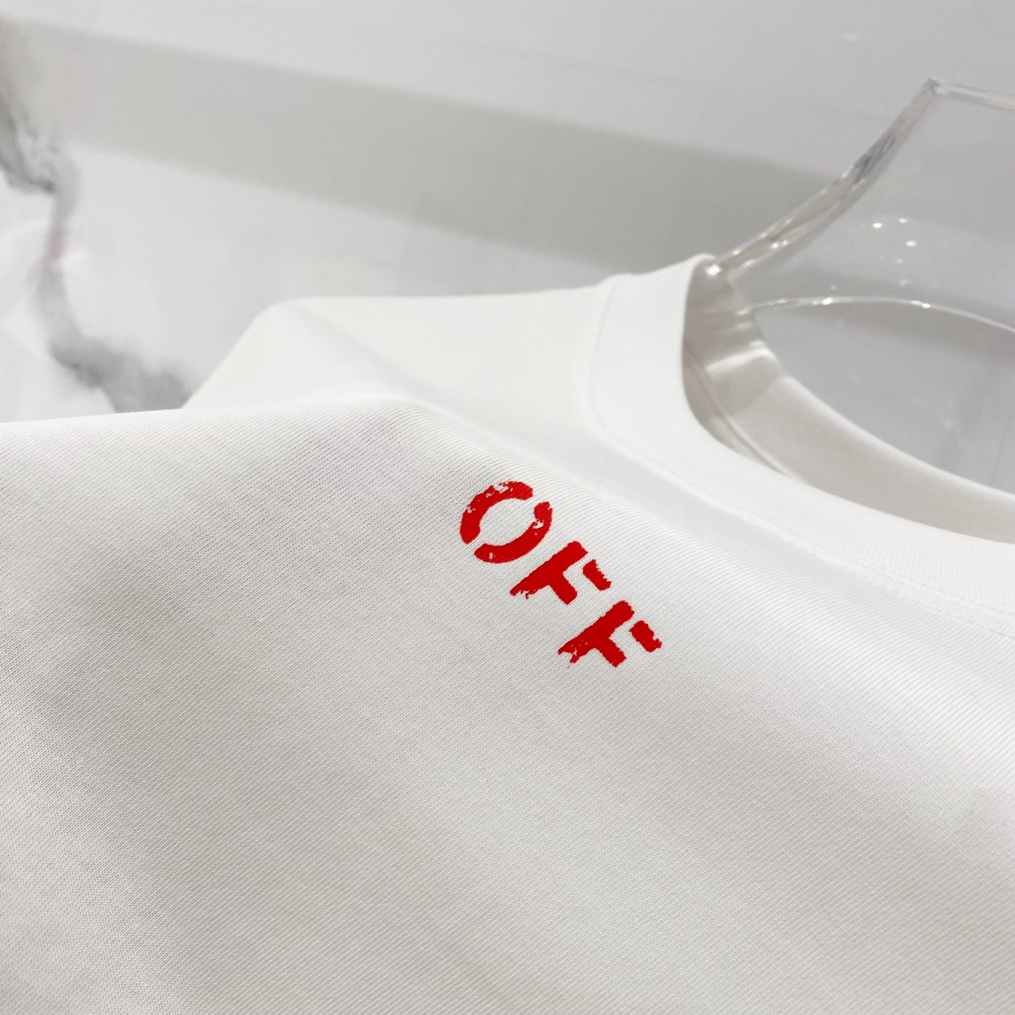 Off White off-white T-shirt close-up with small red 'OFF' print