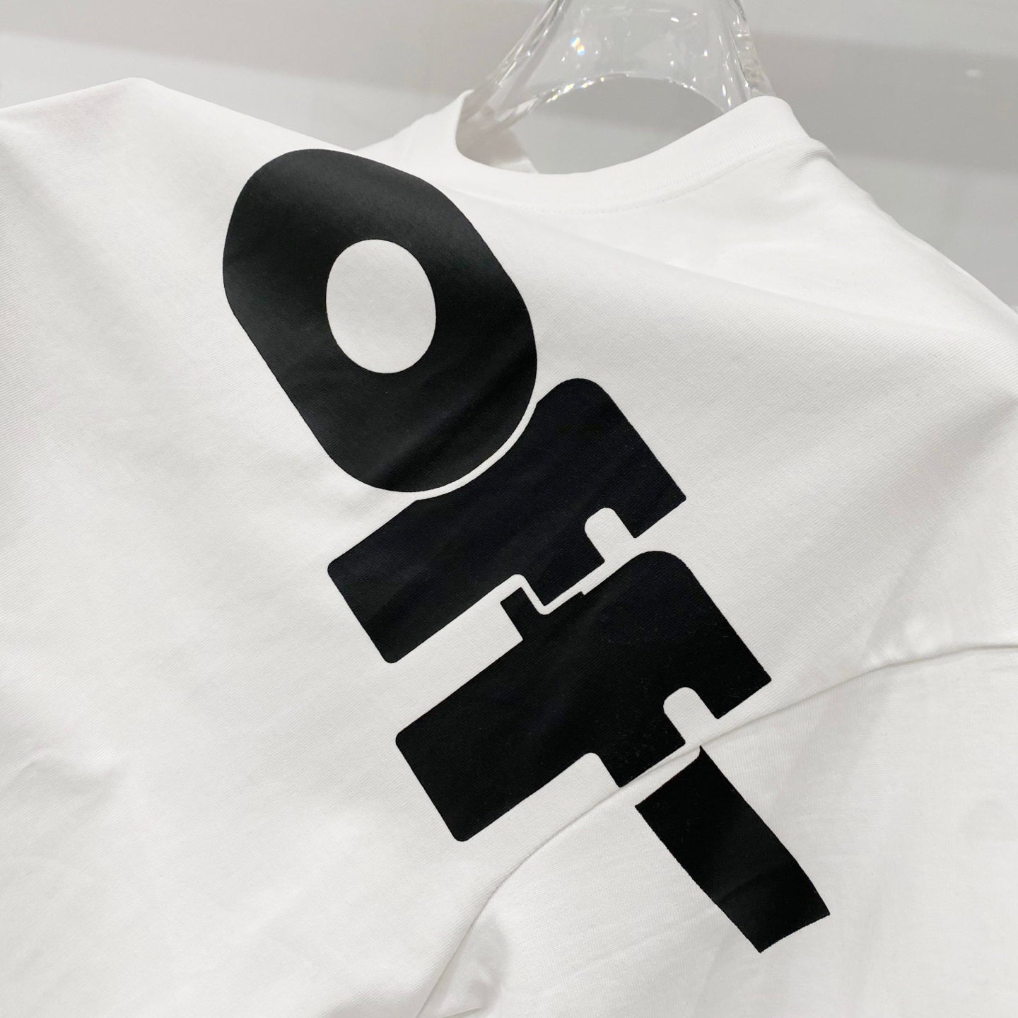 Off White T-shirt with large black logo print across chest