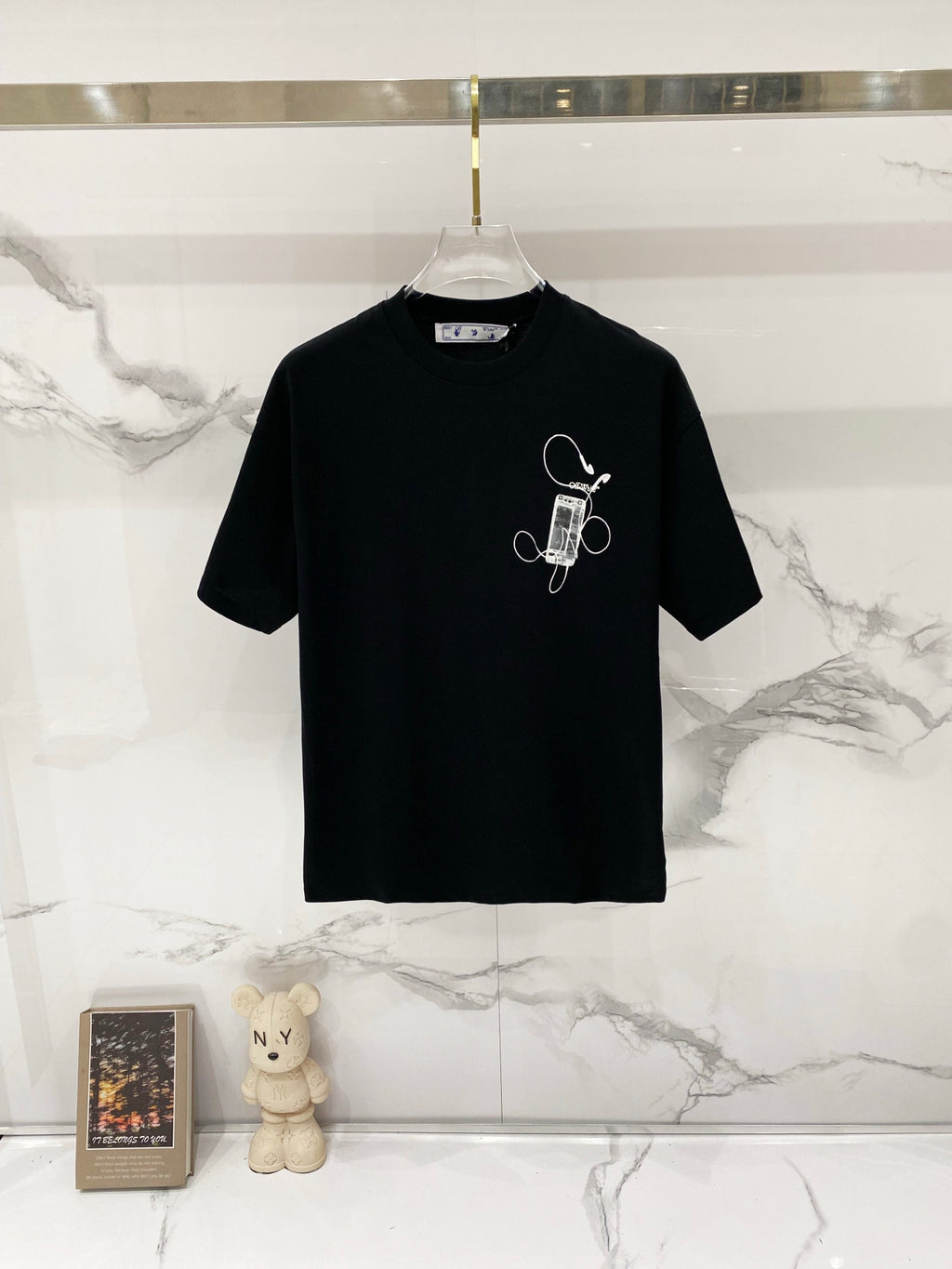 Black graphic T-shirt with small ink-style icon on the chest