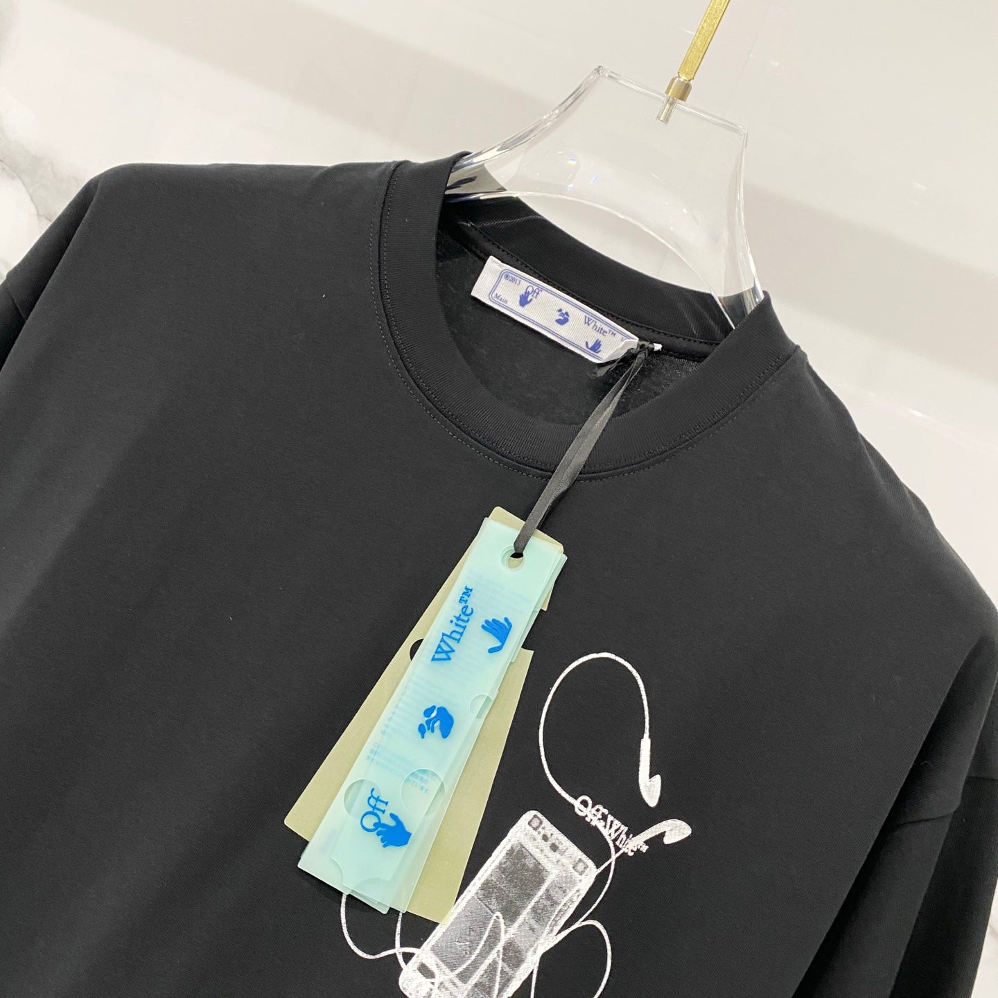 Black T-shirt with white line art icon on the chest