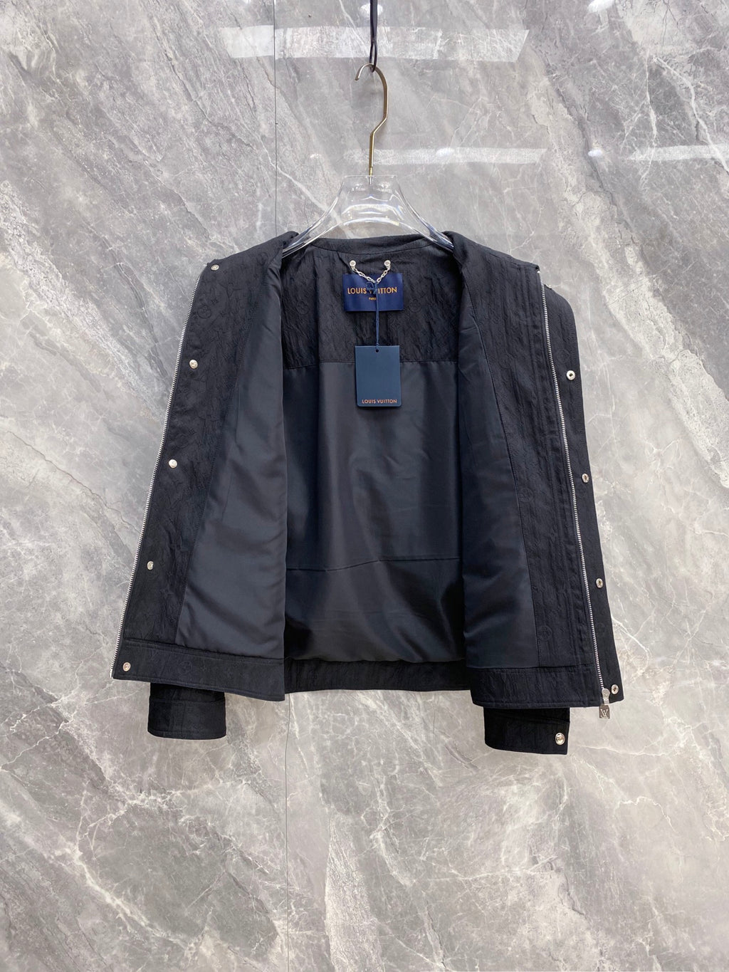 Louis Vuitton long jacket open to show interior lining and monogram panels