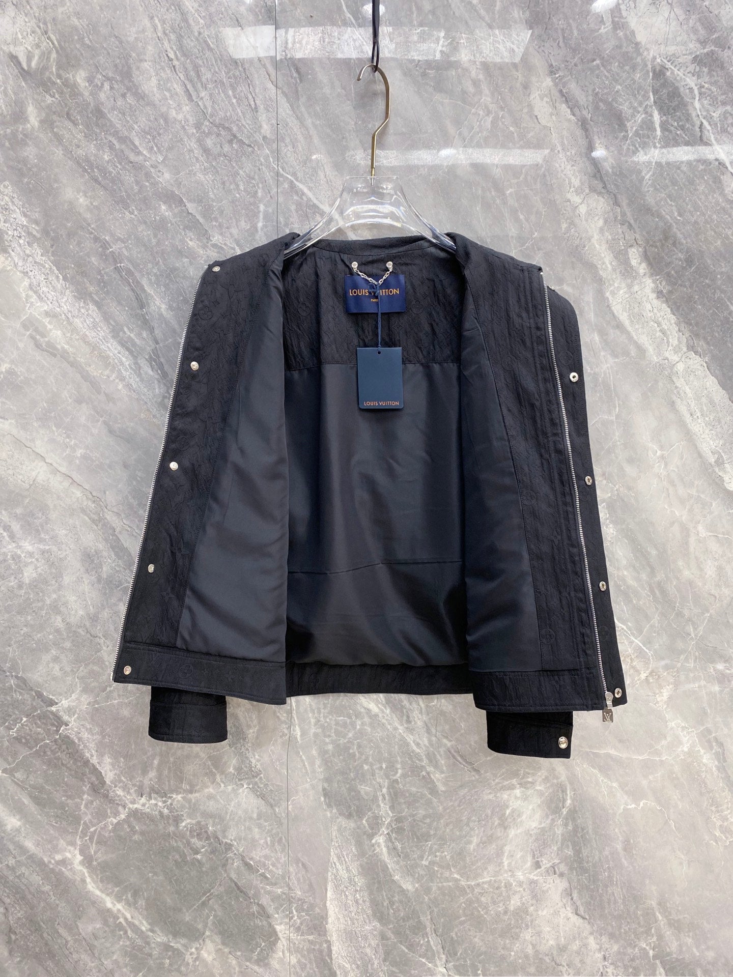 Louis Vuitton long jacket open to show interior lining and monogram panels
