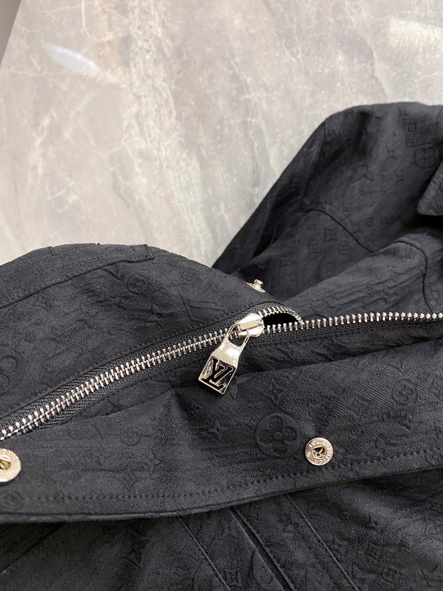 Louis Vuitton long jacket front with zip pull, snap buttons, and monogram texture
