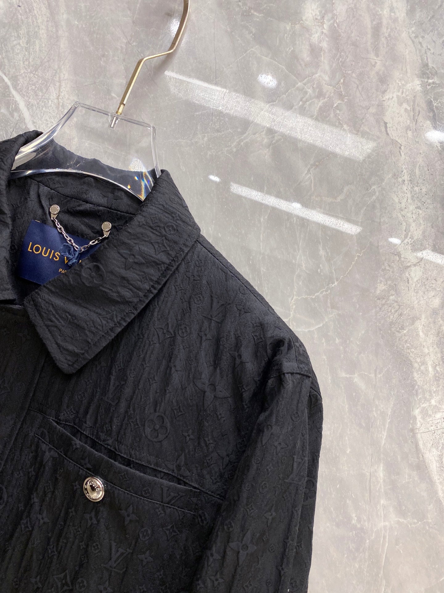 Louis Vuitton long jacket chest panel with embossed monogram and front snap closure