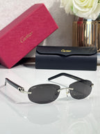 Cartier sunglasses with dark round lenses and metal bridge, front view on display