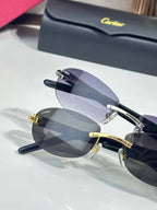 Cartier sunglasses with layered dark lenses and gold frame, front close-up