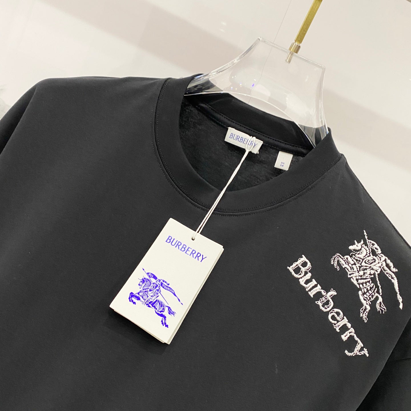 Burberry logo graphic T-shirt, black crewneck with horse emblem and text on the front.