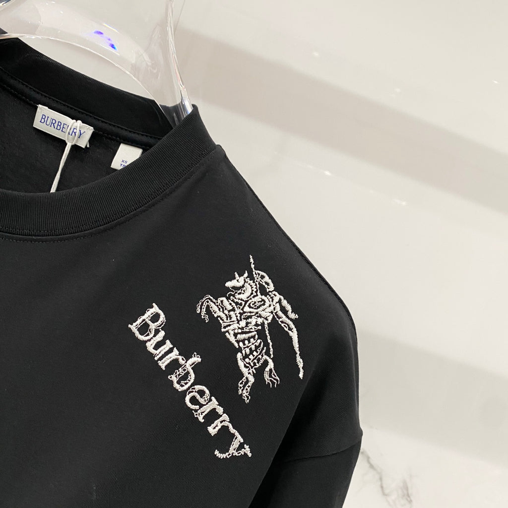 Burberry logo graphic T-shirt side close-up with horse emblem and “Burberry” text.