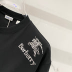 Burberry logo graphic T-shirt side close-up with horse emblem and “Burberry” text.