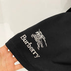Burberry graphic T-shirt sleeve close-up with horse emblem and “Burberry” text.
