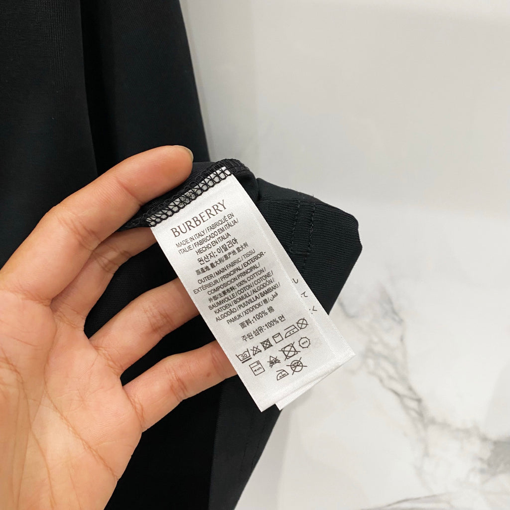 Burberry black T-shirt care and size label inside collar with printed text.