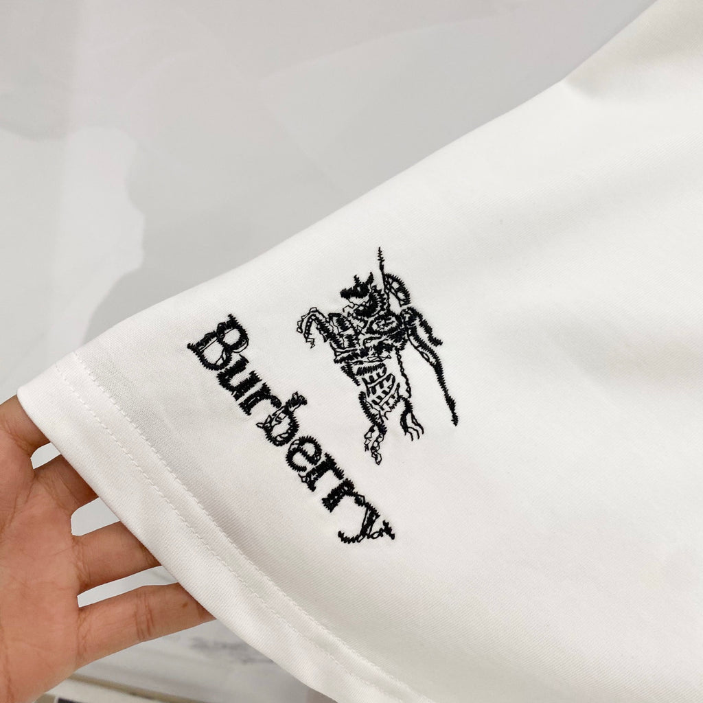 White Burberry T-shirt sleeve close-up with black horse emblem and Burberry text