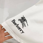White Burberry T-shirt sleeve close-up with black horse emblem and Burberry text