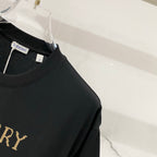 Black short-sleeve T-shirt on clear hanger, Burberry label at collar