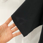 Black short-sleeve T-shirt sleeve hem with visible stitching