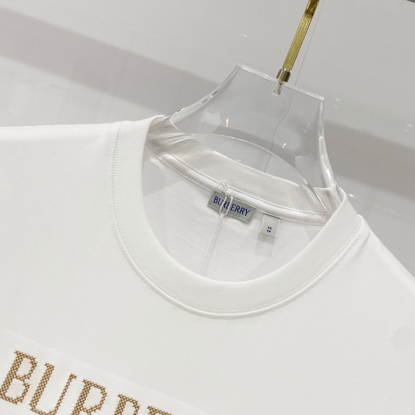 White Burberry T-shirt neckline close-up with brand tag
