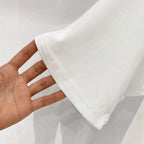 White Burberry T-shirt sleeve and hem held in hand