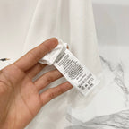 White Burberry T-shirt care label and brand tag close-up
